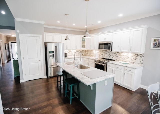 8812 Sanctuary Ln, Louisville, KY 40291 - kitchen featuring appliances with stainless steel finishes, a sink, a breakfast bar area, decorative backsplash, and white cabinetry
