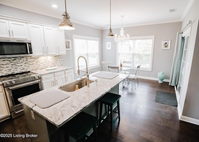 8812 Sanctuary Ln, Louisville, KY 40291 - kitchen with appliances with stainless steel finishes, a sink, dark wood finished floors, light stone countertops, and backsplash