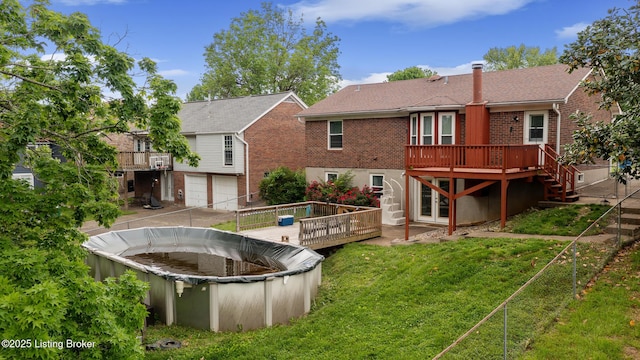 7208 Ridge Creek Rd, Louisville, KY 40291 - back of house with a wooden deck, a garage, brick siding, and driveway
