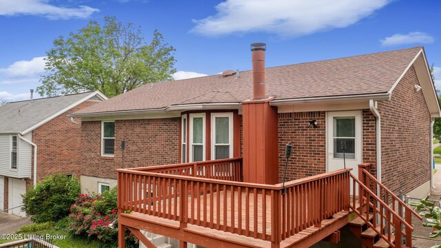 7208 Ridge Creek Rd, Louisville, KY 40291 - back of house with brick siding, a deck, a shingled roof, and an attached garage