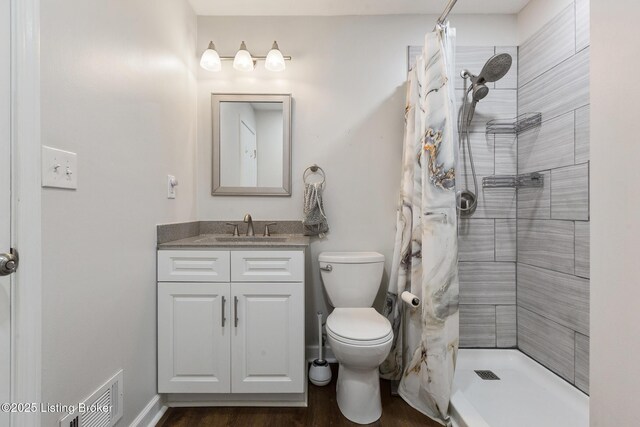 7208 Ridge Creek Rd, Louisville, KY 40291 - bathroom featuring vanity, a tile shower, toilet, and wood finished floors