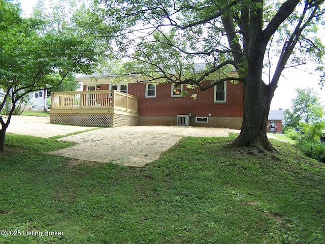 132 Goodloe Ave, Bloomfield, KY 40008 - back of property featuring central air condition unit, a deck, a yard, and brick siding
