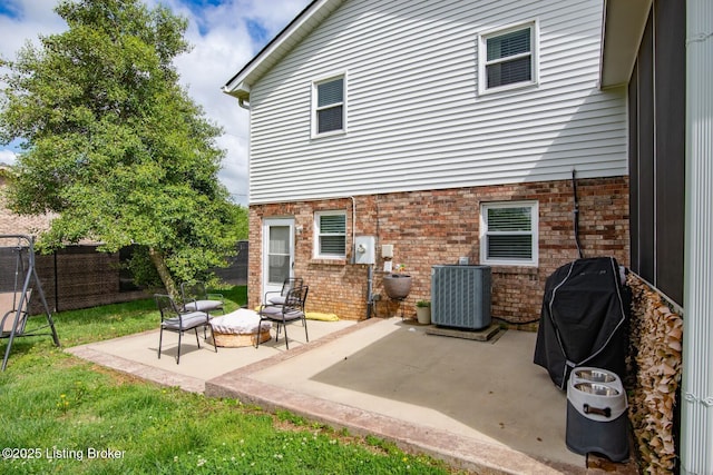 395 Poplar Trce, Elizabethtown, KY 42701 - back of property featuring central air condition unit, fence, a patio, and brick siding