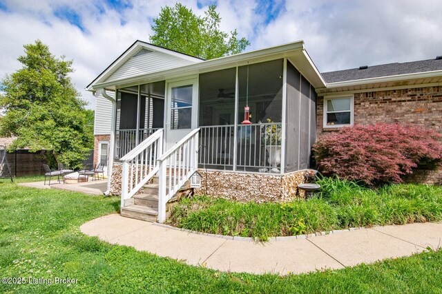 395 Poplar Trce, Elizabethtown, KY 42701 - view of front of home with brick siding, a sunroom, and a patio area