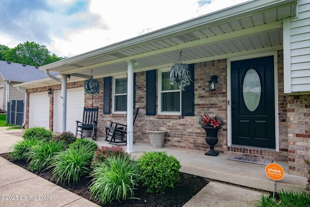 395 Poplar Trce, Elizabethtown, KY 42701 - doorway to property with a porch, a garage, concrete driveway, and brick siding