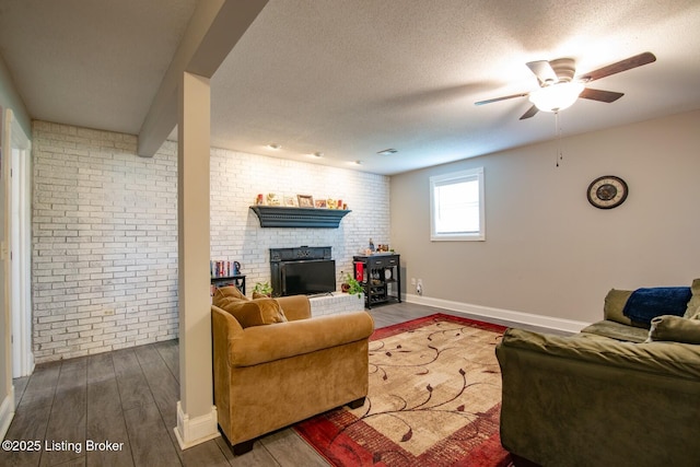 395 Poplar Trce, Elizabethtown, KY 42701 - living room with wood finished floors, a ceiling fan, brick wall, a fireplace, and baseboards