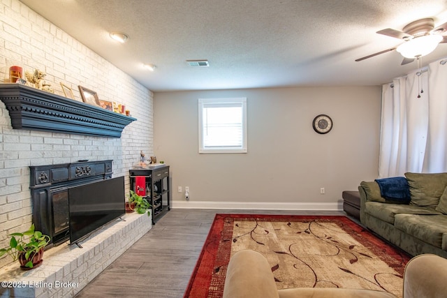 395 Poplar Trce, Elizabethtown, KY 42701 - living room with a ceiling fan, wood finished floors, a textured ceiling, baseboards, and brick wall