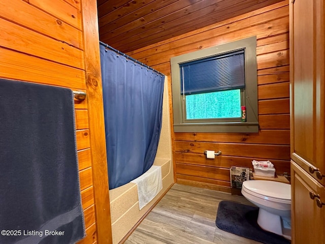 2212 Duff Rd, Leitchfield, KY 42754 - full bath featuring toilet, wood finished floors, wood walls, wood ceiling, and shower / bath combination with curtain