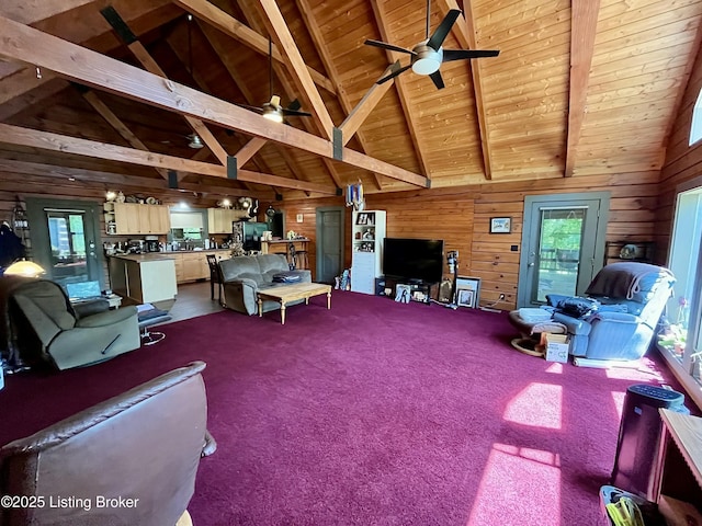 2212 Duff Rd, Leitchfield, KY 42754 - living area with wood walls, plenty of natural light, ceiling fan, wooden ceiling with exposed beams, and high vaulted ceiling