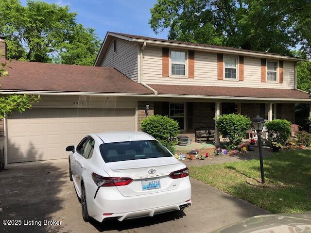 8907 Lakeridge Dr, Louisville, KY 40272 - view of front of house featuring a porch, driveway, and an attached garage