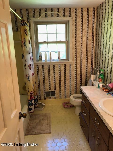 8907 Lakeridge Dr, Louisville, KY 40272 - bathroom featuring tile patterned flooring, toilet, vanity, and shower / tub combo with curtain