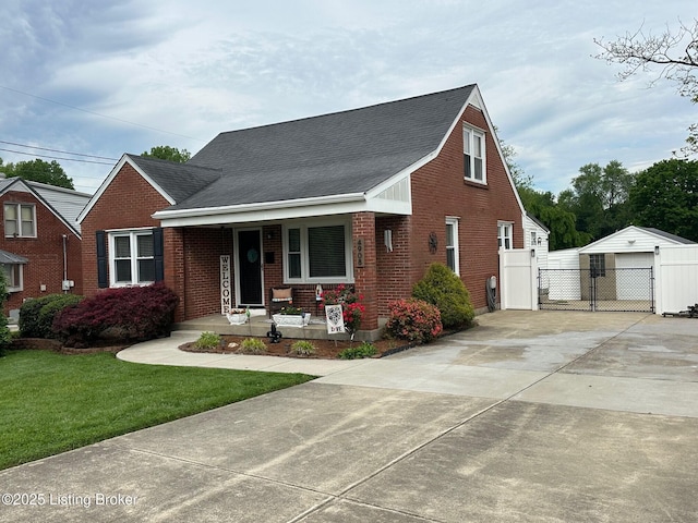 4908 Fielding Way, Louisville, KY 40216 - view of front of home with covered porch, a gate, brick siding, and roof with shingles