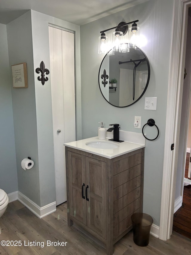 4908 Fielding Way, Louisville, KY 40216 - bathroom with wood finished floors, vanity, toilet, and baseboards