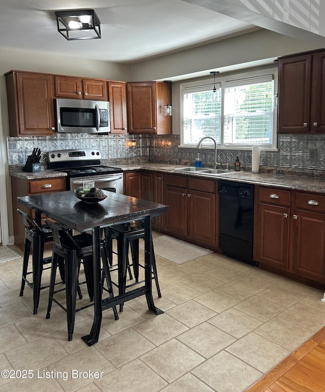 4908 Fielding Way, Louisville, KY 40216 - kitchen featuring stainless steel appliances, dark countertops, a sink, and backsplash