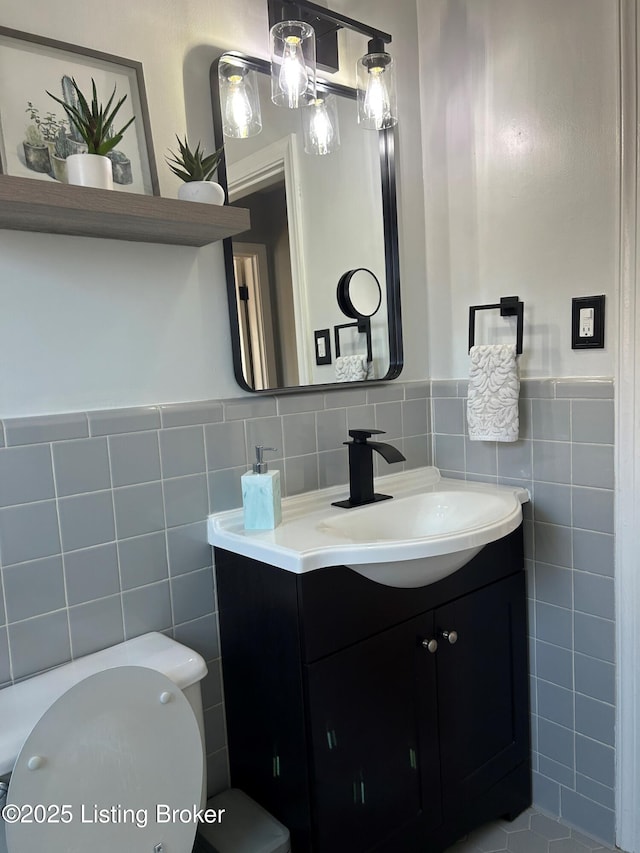 4908 Fielding Way, Louisville, KY 40216 - half bathroom featuring tile walls, vanity, toilet, and wainscoting
