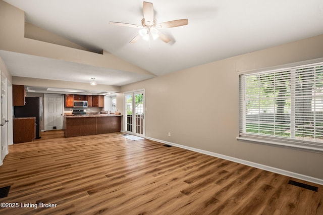 10707 Hickory Cove Ct, Louisville, KY 40245 - unfurnished living room featuring vaulted ceiling, wood finished floors, baseboards, and a ceiling fan