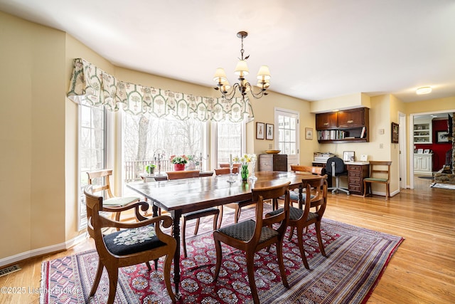 1309 S Buckeye Ln, Goshen, KY 40026 - dining area featuring a chandelier, light wood-style floors, and baseboards