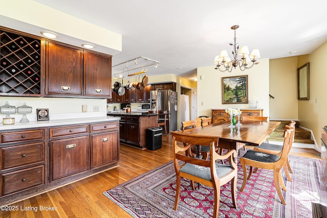 1309 S Buckeye Ln, Goshen, KY 40026 - dining space featuring wood finished floors and a chandelier