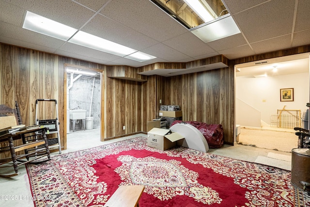 1309 S Buckeye Ln, Goshen, KY 40026 - basement with wooden walls, a drop ceiling, carpet, and a sink