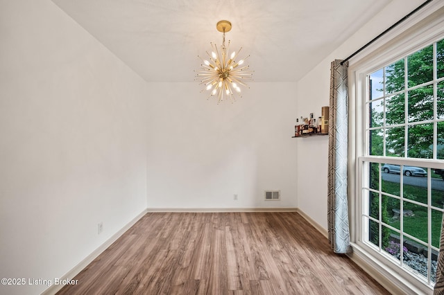 8200 Casualwood Way, Louisville, KY 40291 - unfurnished dining area with a chandelier, wood finished floors, and baseboards