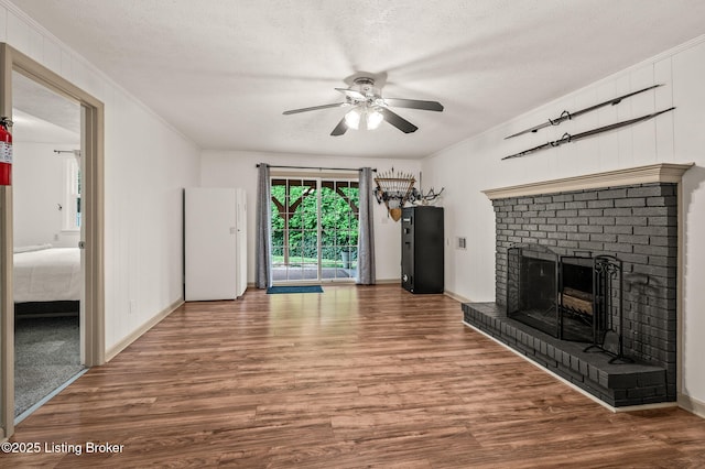 8200 Casualwood Way, Louisville, KY 40291 - unfurnished living room featuring ceiling fan, wood finished floors, baseboards, a brick fireplace, and crown molding