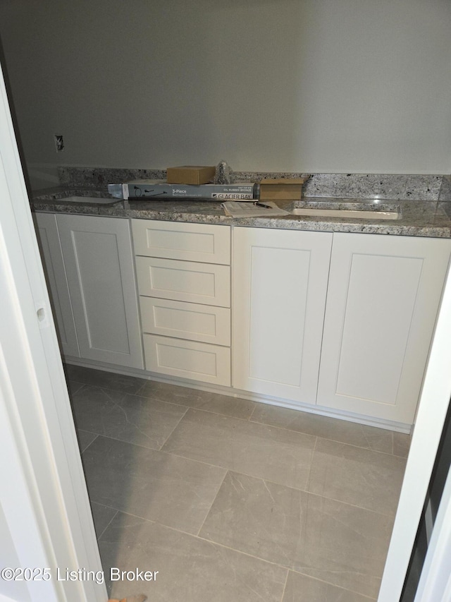 bathroom featuring marble finish flooring