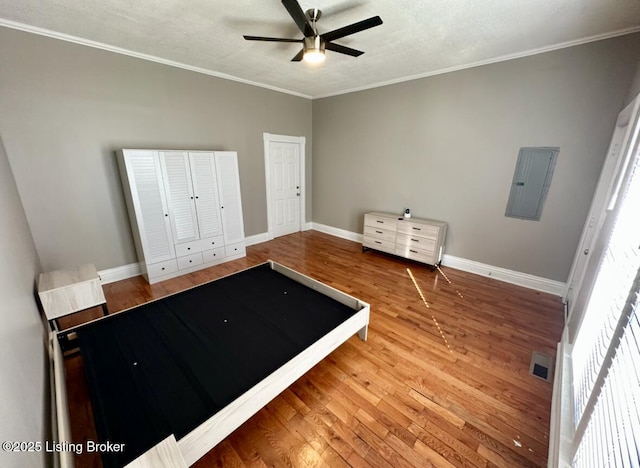 2512 S 4th St, Louisville, KY 40208 - unfurnished bedroom featuring electric panel, wood finished floors, baseboards, ornamental molding, and a textured ceiling