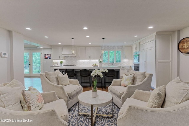living room featuring recessed lighting, plenty of natural light, and wood finished floors