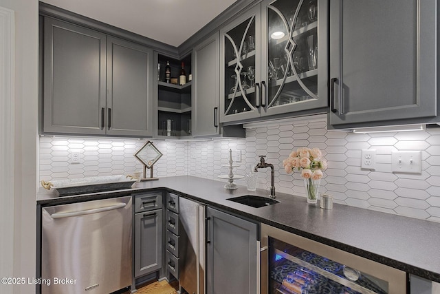 indoor wet bar with dishwasher, beverage cooler, and backsplash