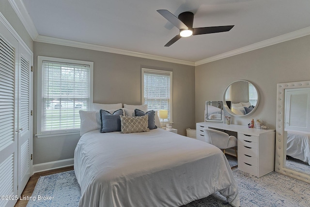 bedroom with multiple windows, crown molding, baseboards, light wood-type flooring, and ceiling fan