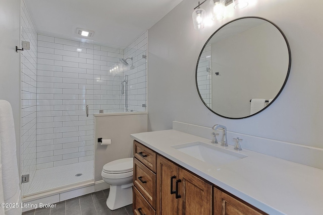 full bathroom featuring toilet, tile patterned flooring, a stall shower, and vanity