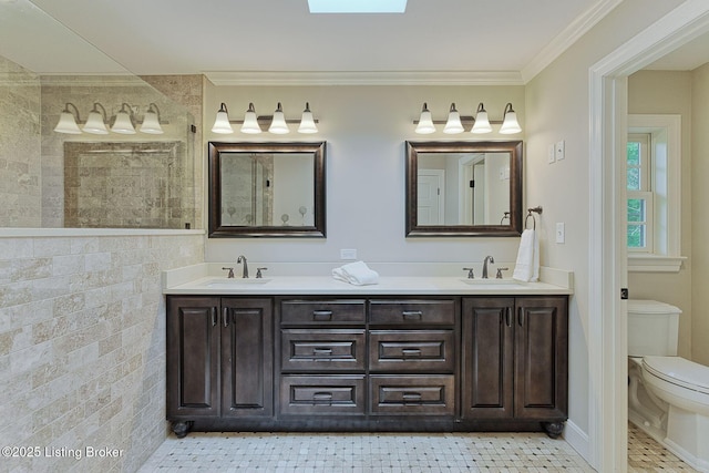 bathroom with toilet, double vanity, crown molding, a walk in shower, and tile patterned floors