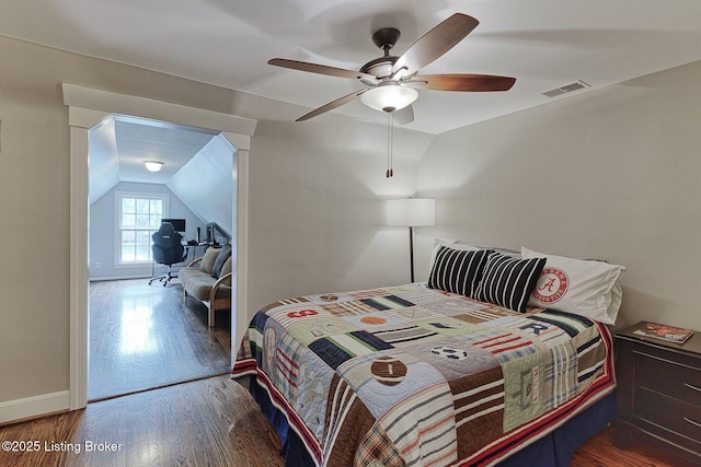 bedroom featuring vaulted ceiling, wood finished floors, baseboards, and ceiling fan