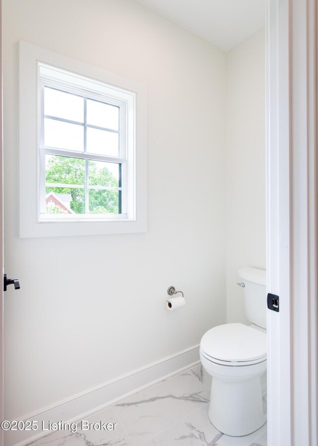 4227 Stilger Cir, Louisville, KY 40299 - bathroom featuring marble look tiles, toilet, and baseboards