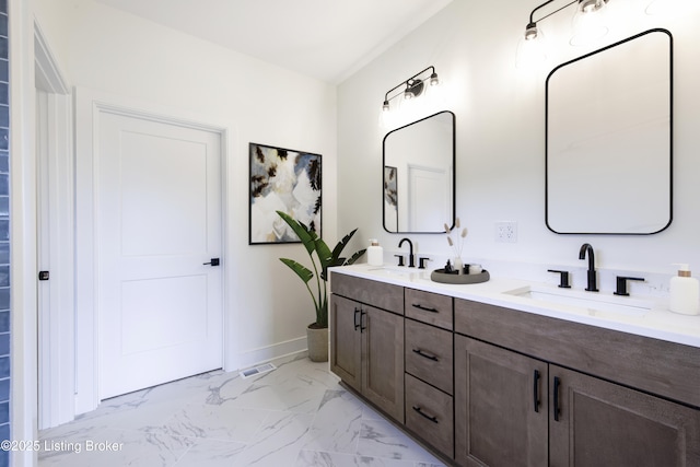 4227 Stilger Cir, Louisville, KY 40299 - bathroom with marble finish flooring, double vanity, and baseboards