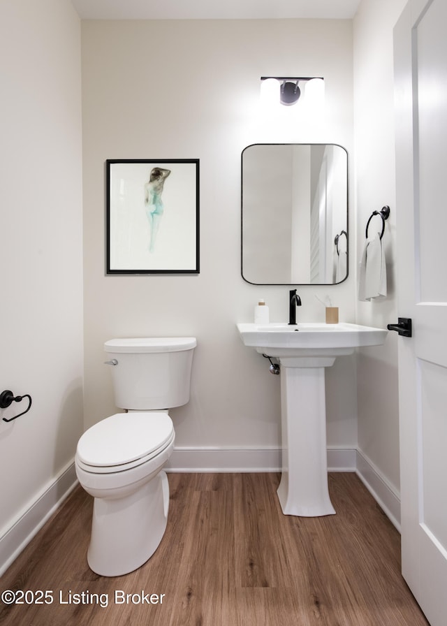 4227 Stilger Cir, Louisville, KY 40299 - half bathroom featuring wood finished floors, baseboards, and toilet