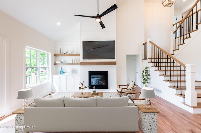 4227 Stilger Cir, Louisville, KY 40299 - living area featuring light wood-style floors, a large fireplace, stairway, high vaulted ceiling, and recessed lighting