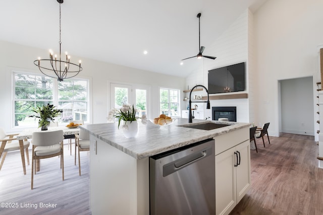 4227 Stilger Cir, Louisville, KY 40299 - kitchen with dishwasher, a sink, a fireplace, a chandelier, and light wood-style flooring