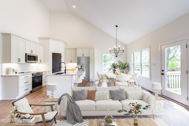 4227 Stilger Cir, Louisville, KY 40299 - living area featuring high vaulted ceiling, a chandelier, light wood-style flooring, and recessed lighting