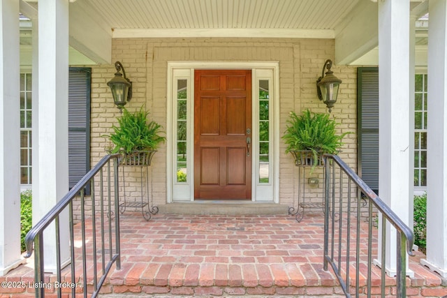 view of exterior entry with brick siding