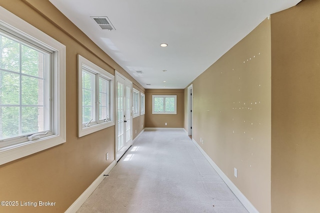 hallway with baseboards and recessed lighting