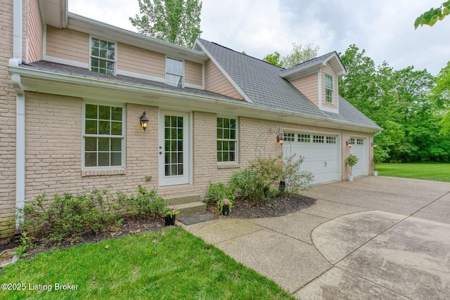 view of front of house with concrete driveway, an attached garage, brick siding, and entry steps