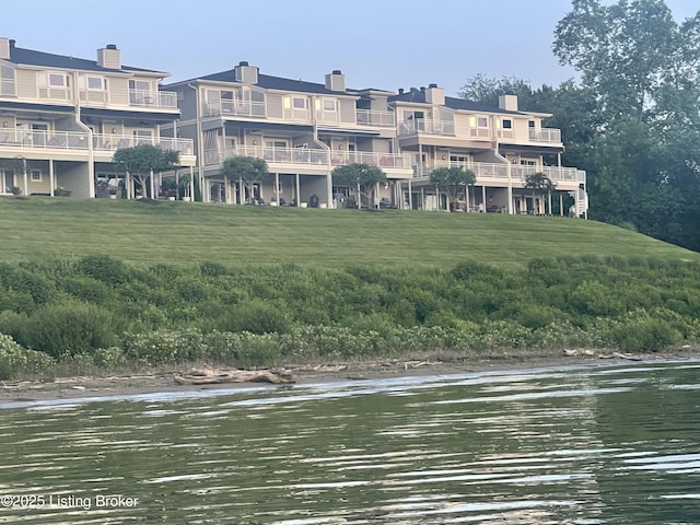 surrounding community featuring a water view and a yard