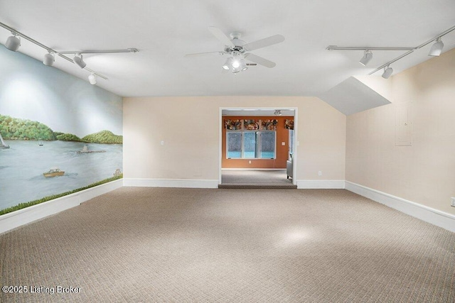 unfurnished room featuring track lighting, ceiling fan, carpet, and baseboards