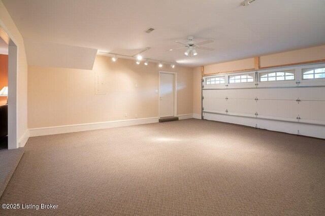 garage featuring ceiling fan and baseboards
