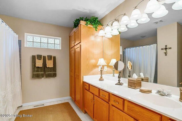 full bathroom featuring vanity, tile patterned flooring, and baseboards