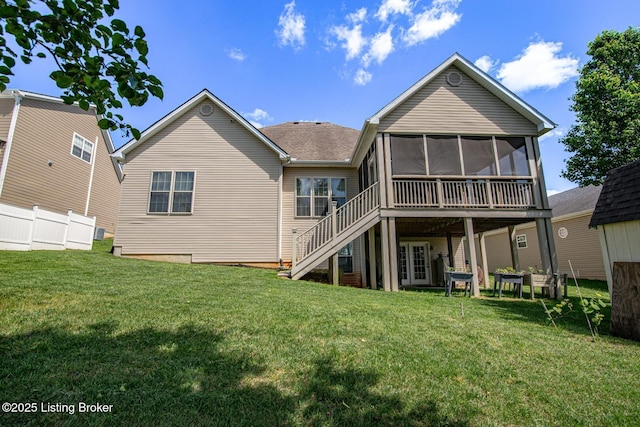 rear view of house featuring a sunroom, stairway, and a shingled roof