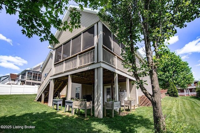 back of property featuring a sunroom, a deck, and stairs