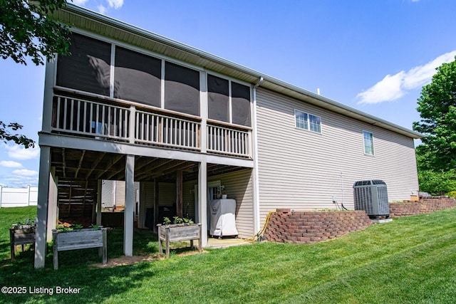 back of property with central AC unit and a lawn