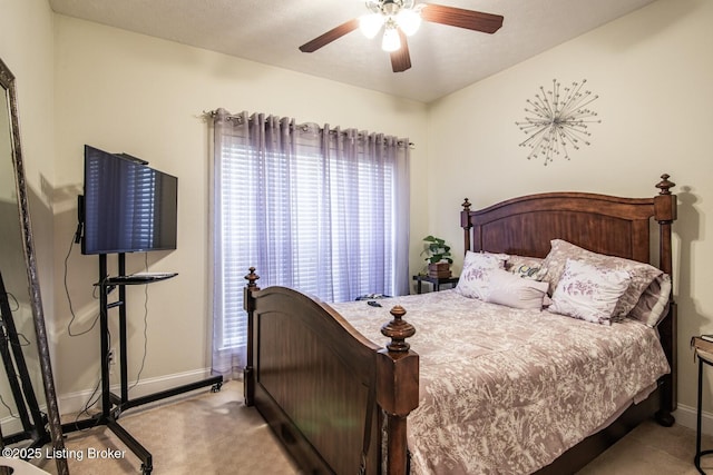 bedroom with baseboards, carpet flooring, and a ceiling fan